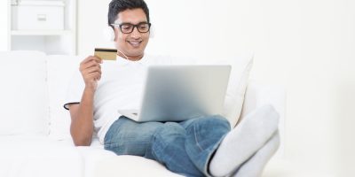 Asian man internet shopping indoor relaxed
