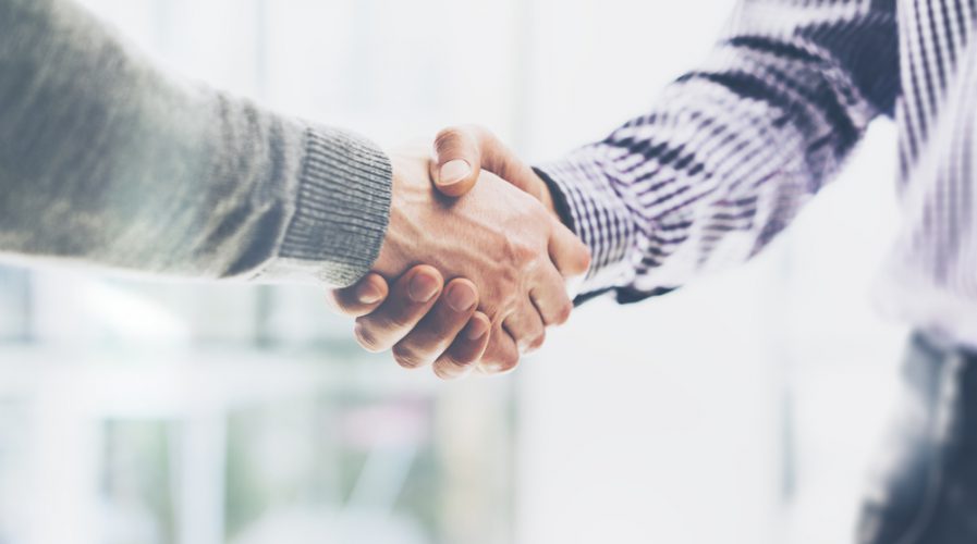 Business partnership handshake meeting concept