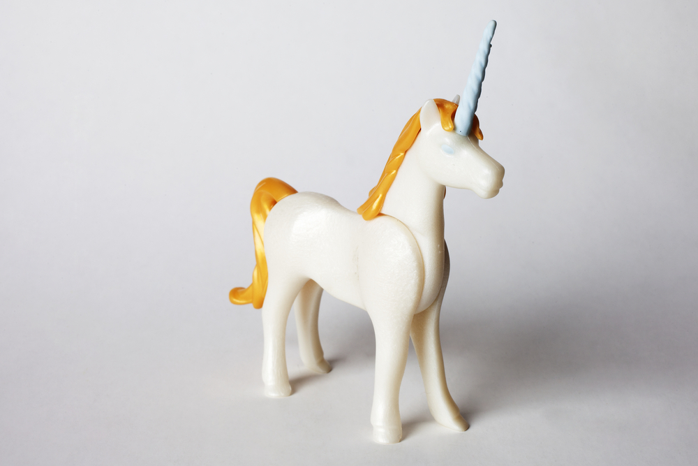 Toy unicorn over white background
