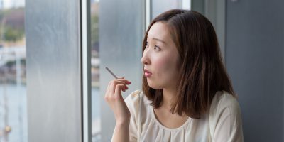 asian woman with cigarette