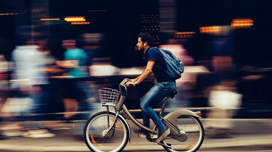 man riding a bicycle in a crowded city
