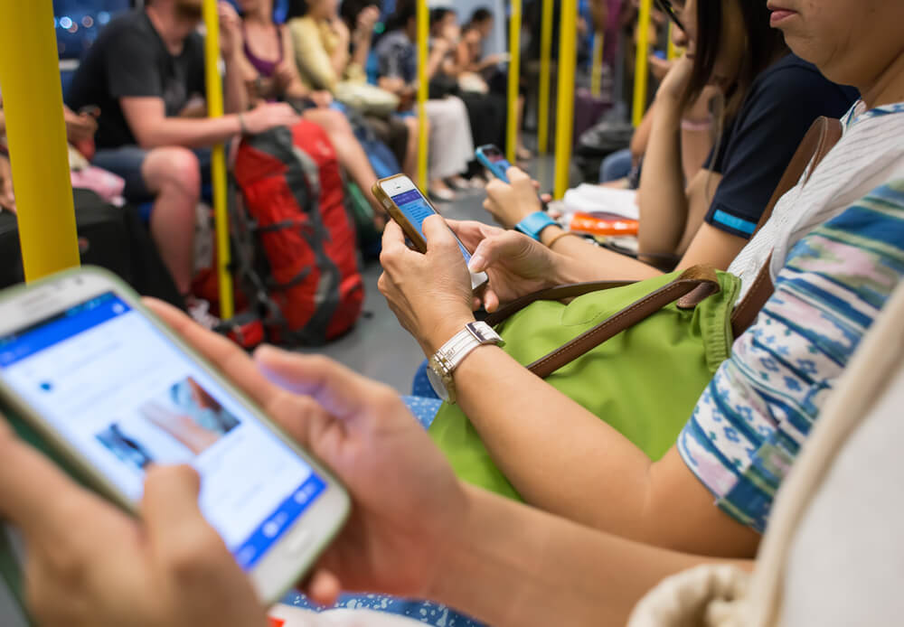 users on mobile phones in a train 