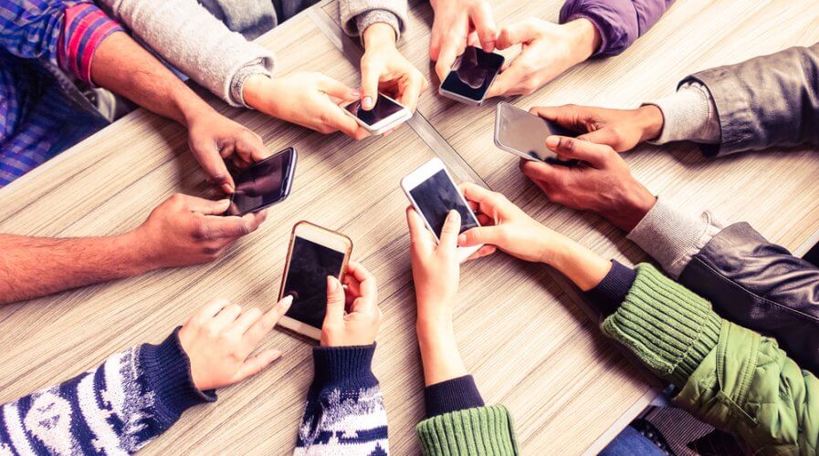 a group of people using mobile phones.