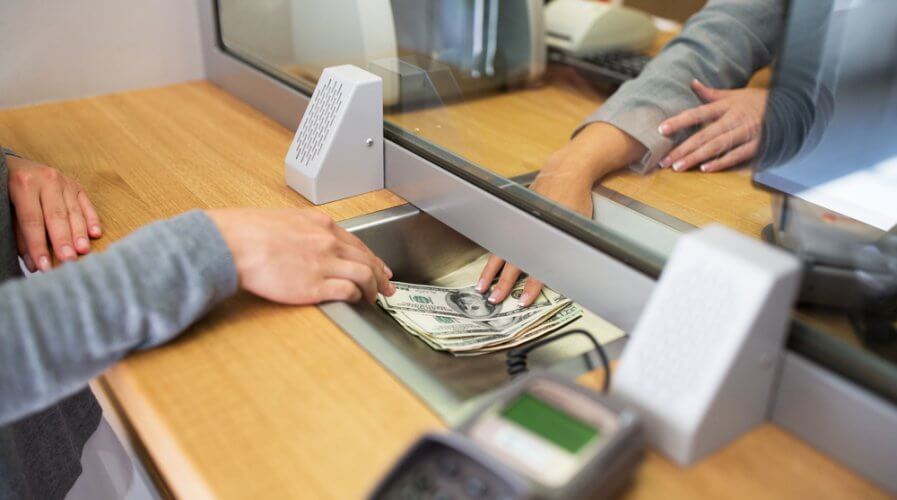 a banking counter with someone withdrawing money