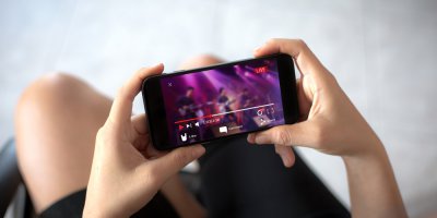 a person livestreaming video on their mobile phone