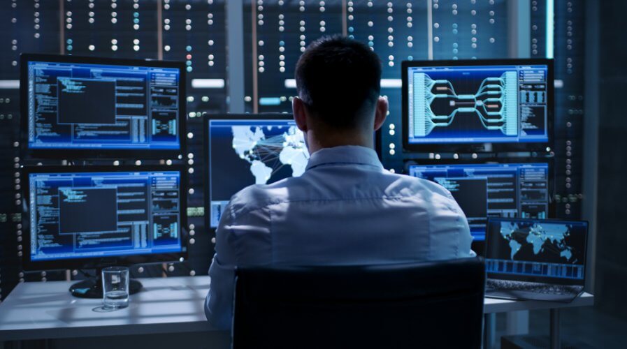 a man working in a surveillance control room