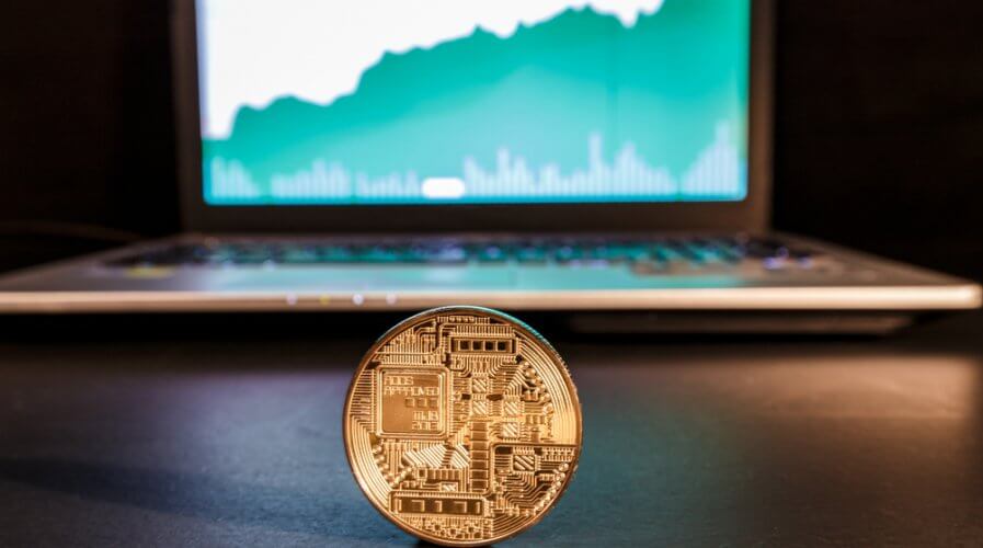a cryptocoin in front of a computer
