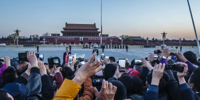 people with mobile phones waiting outside Tiananmen square