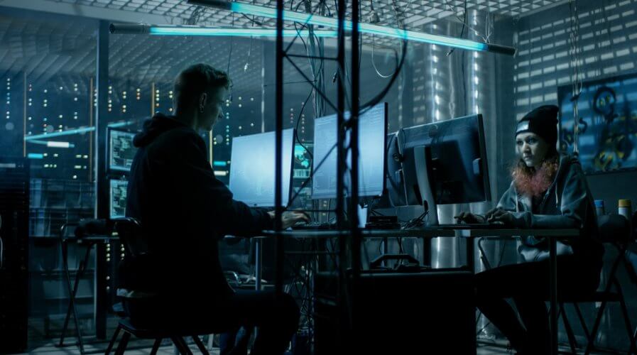 a team of hackers working in a dark room