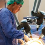a doctor operates with the help of precision robots