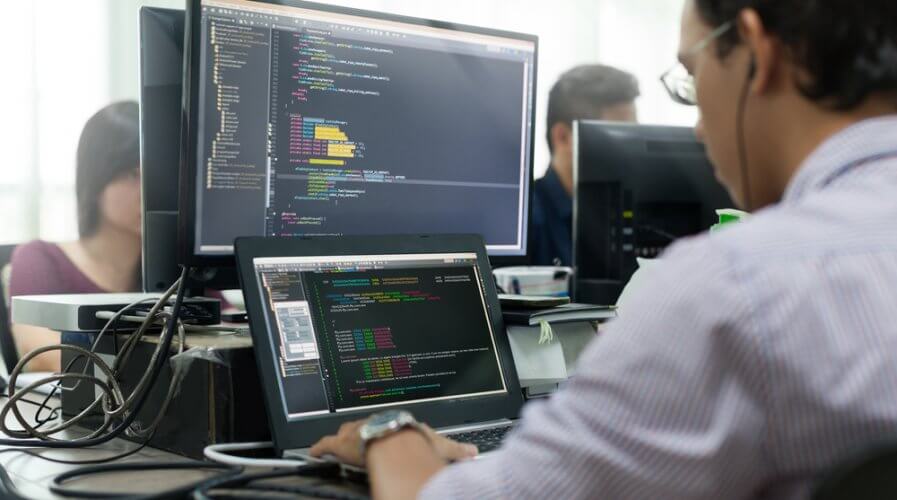 a software developer writing code on a screen