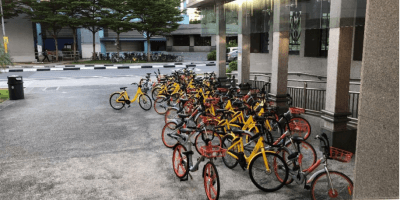 bikes being parked haphazardly near an MRT station