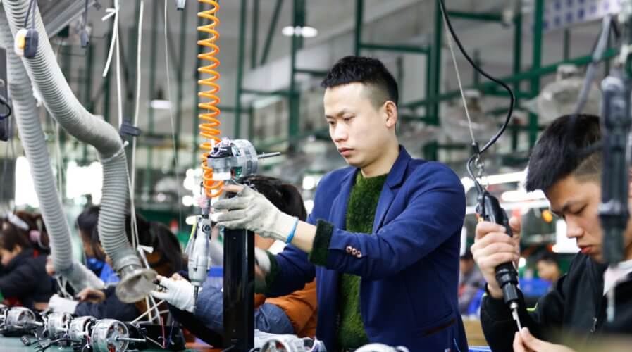 a man working in the assembly line for an electronics product