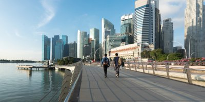people walking with the backdrop of singapore's financial district