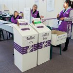 officials at a polling place in australia