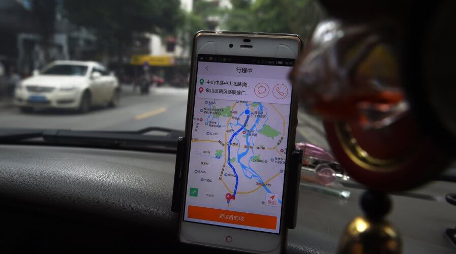 China's largest ride-hailing services provider recently launched a web of financial services integrated to its app to boost profit. Source: GREG BAKER / AFP