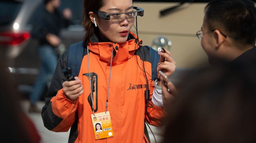 AI-powered augmented reality glasses can help China break the infection chain. Source: AFP