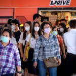 Commuters with face masks at a busy train station in Thailand. Source: AFP.