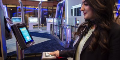 An attendant does the test of facial recognition using biometry technology in the "innovation hub" of Istanbul airport. Source: AFP