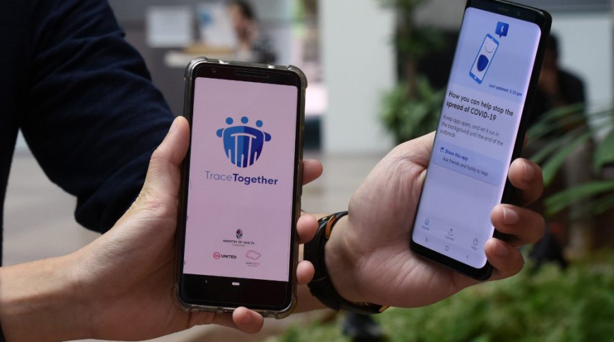 Government Technology Agency (GovTech) staff demonstrate Singapore's new contact-tracing smarthphone app called TraceTogether, as a preventive measure against the COVID-19 coronavirus in Singapore