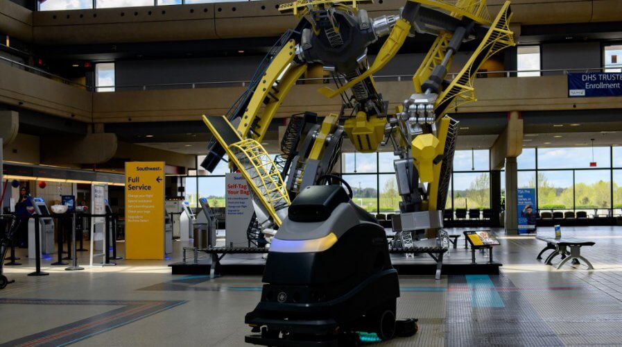 A UV floor cleaning robot cleans the floor near the ticketing windows at Pittsburgh International Airport.