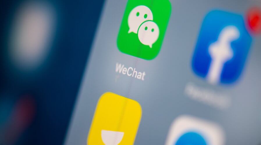 The logo of the Chinese instant messaging application WeChat on the screen of a tablet