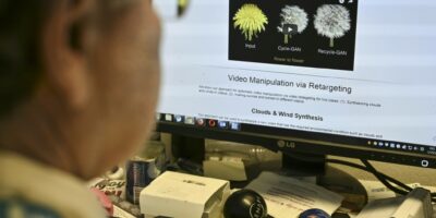An AFP journalist views an example of a "deepfake" video manipulated using artificial intelligence