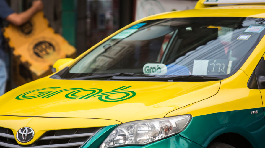 Grab branded taxi cab on the street of Bangkok