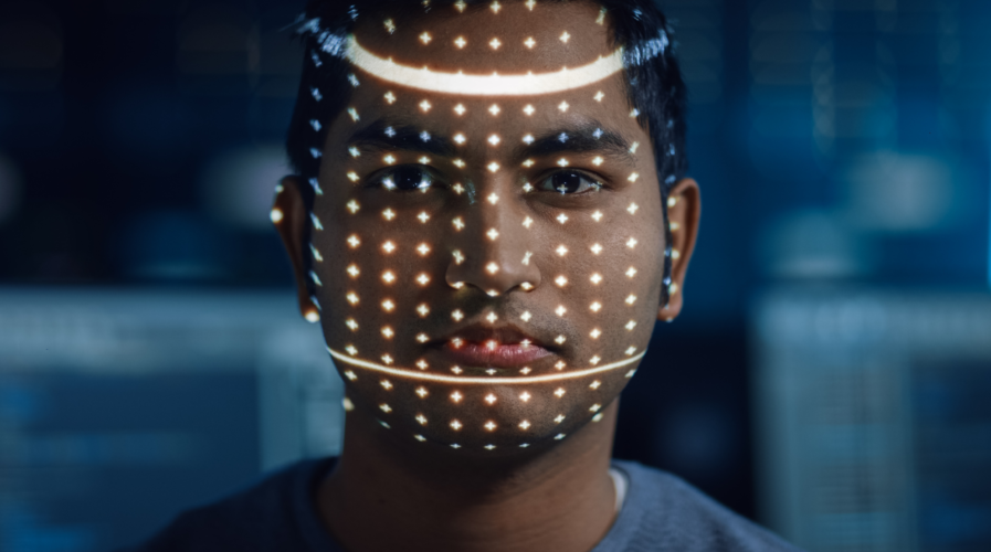 Handsome Young Indian Man is Identified by Biometric Facial Recognition Scanning Process. Futuristic Concept: Projector Identifies Individual by Illuminating Face by Dots and Scanning with Laser