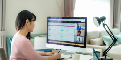 Asian business woman talking to her colleagues about plan in video conference. Multiethnic business team using computer for a online meeting in video call. Group of people smart working from home.