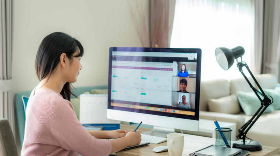 Asian business woman talking to her colleagues about plan in video conference. Multiethnic business team using computer for a online meeting in video call. Group of people smart working from home.