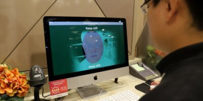 GovTech demonstrating the biometric facial verification tech to access government services, part of its digital government initiatives.