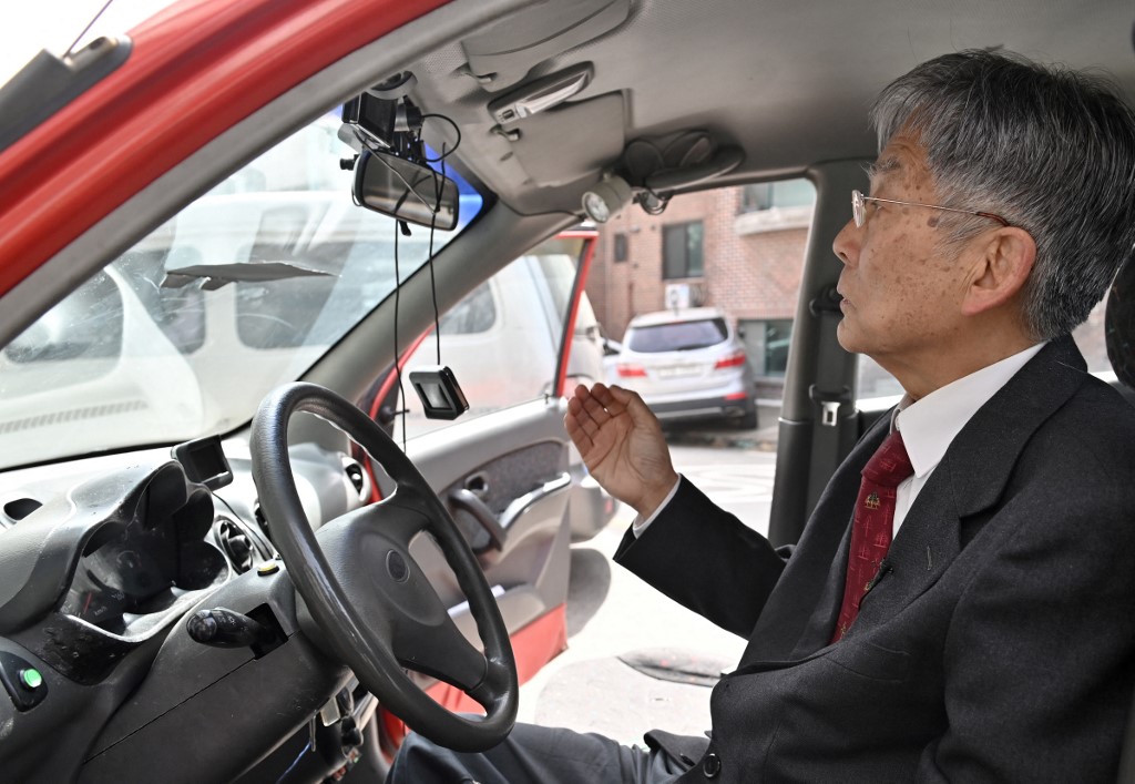Retired South Korean professor Han Min-hong sitting in his 21-year-old self-driving car in Yongin, south of Seoul