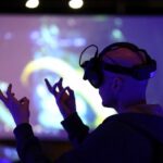 Virtual Production offers applications across multiple industries. Here, an attendee tries out augmented reality glasses at the AWE Expo Santa Clara. (Photo by JUSTIN SULLIVAN / GETTY IMAGES NORTH AMERICA / Getty Images via AFP)