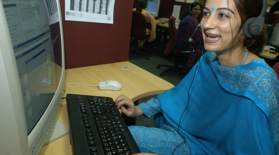 An unidentified employee of the HSBC call centre attends to a call in the call centre in Hyderabad (Photo by DIBYANGSHU SARKAR / AFP)