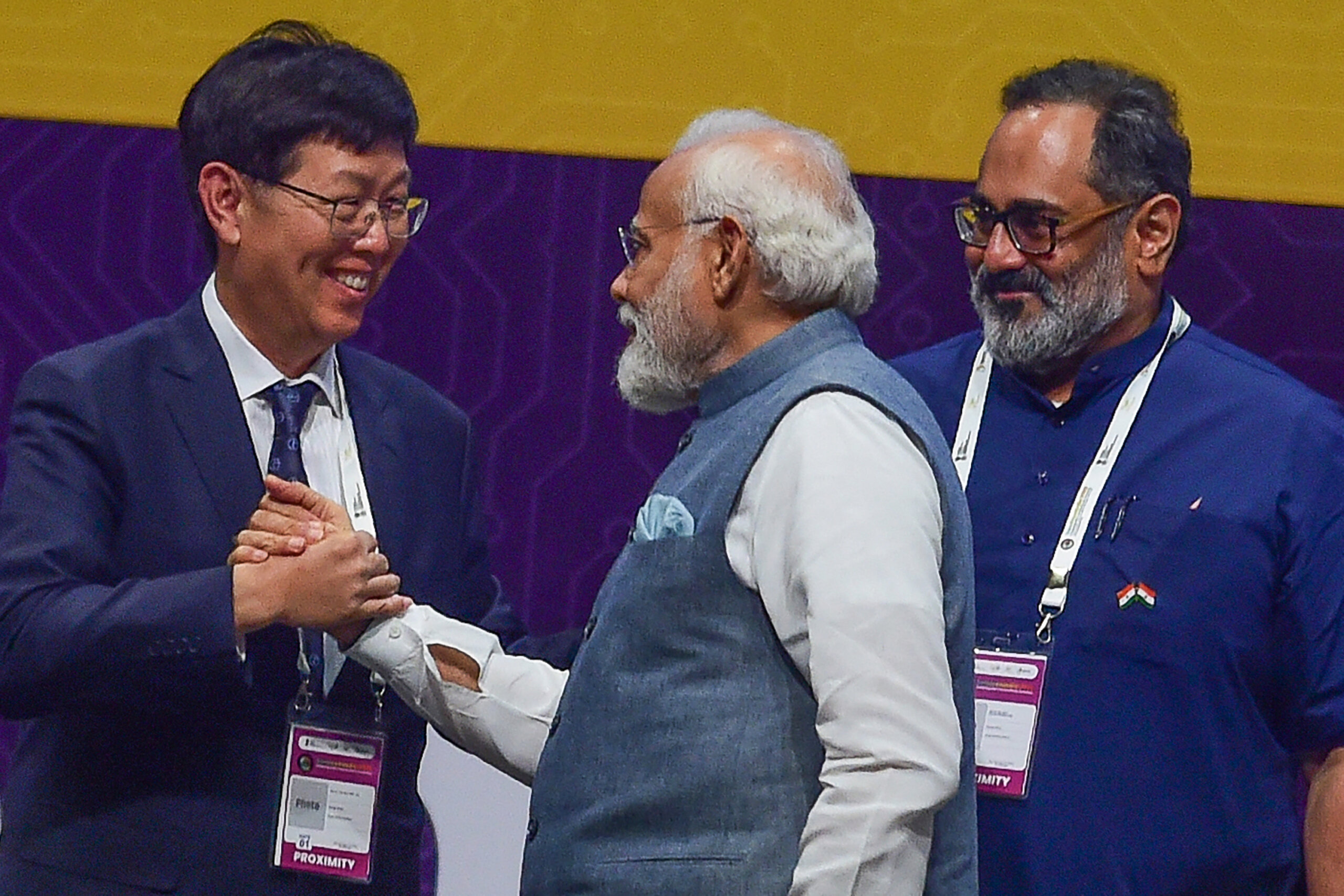 Foxconn Chairman and CEO Young Liu (L) greets Indian Prime Minister Narendra Modi (C), during SemiconIndia 2023, at Mahatma Mandir in Gandhinagar on July 28, 2023. (Photo by SAM PANTHAKY / AFP)