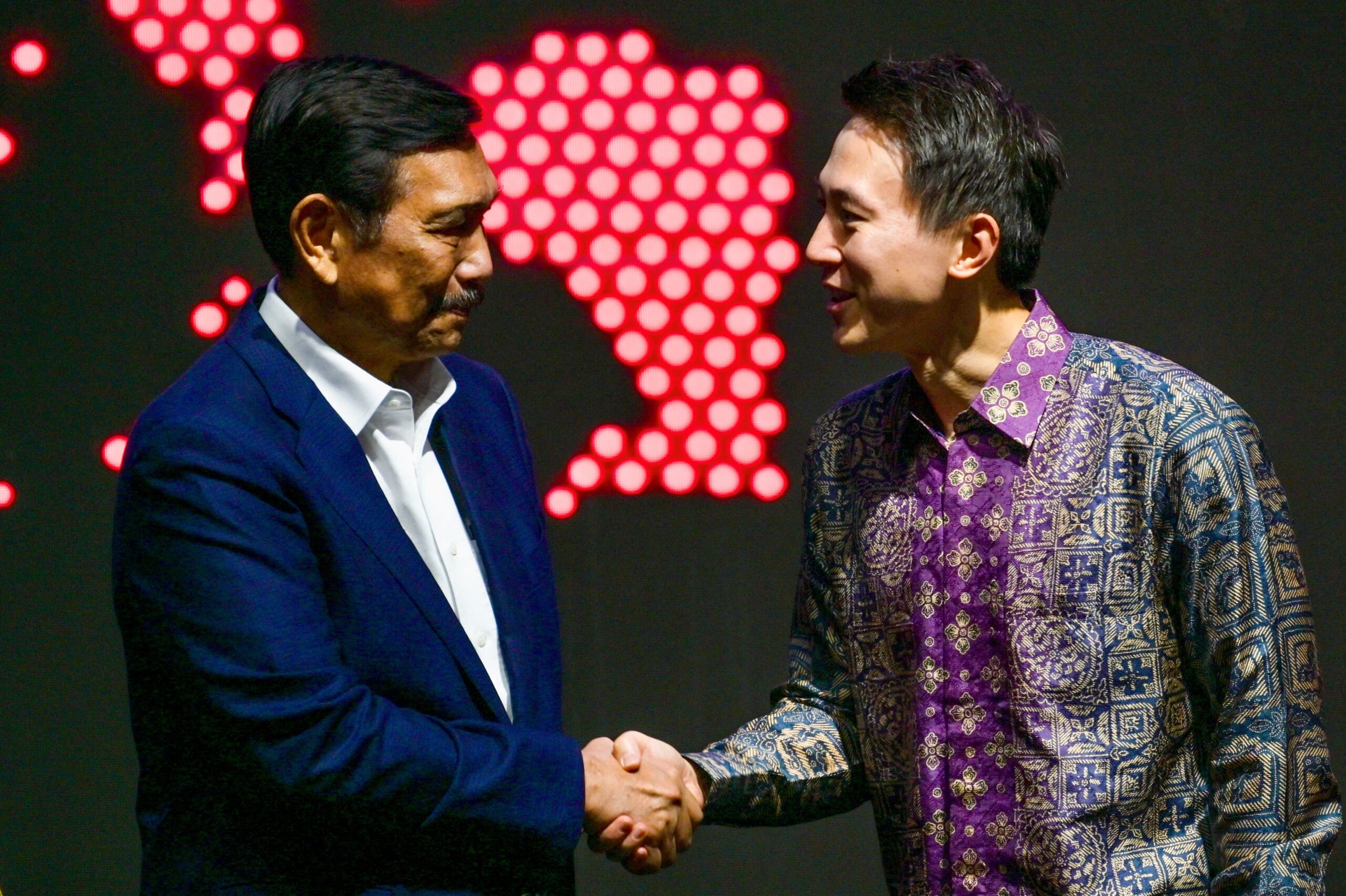 TikTok CEO Shou Zi Chew (R) shakes hands with Indonesian Coordinating Minister for Maritime Affairs and Investment Luhut Binsar Pandjaitan during the TikTok Southeast Asia Impact Forum 2023 in Jakarta on June 15, 2023. (Photo by BAY ISMOYO / AFP)