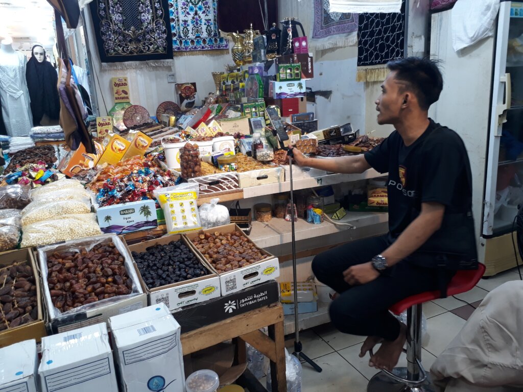 Jakarta, Indonesia - July 2nd, 2023: Hajj souvenirs vendor doing live selling on Tiktok. Live sale online.