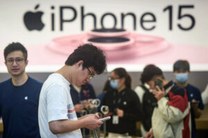 A man tries out a newly-launched iPhone 15 mobile phone at an Apple store in Hangzhou, in China's eastern Zhejiang province on September 22, 2023. (Photo by AFP) / China OUT
