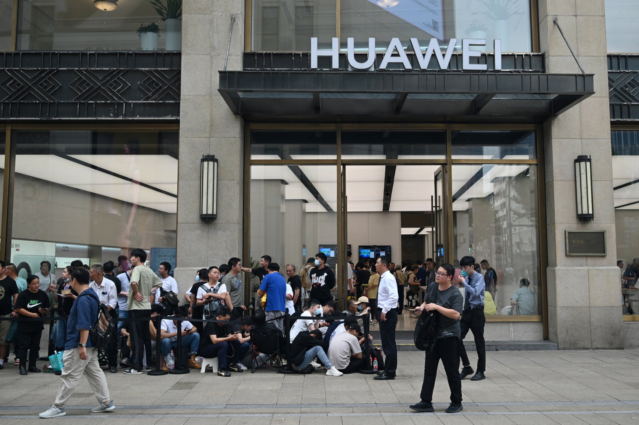 People queue up for hours outside Huawei's flagship store in Shanghai on September 25, 2023, hoping to be able to buy the tech giant's latest Mate 60 Pro mobile phone. (Photo by REBECCA BAILEY / AFP)