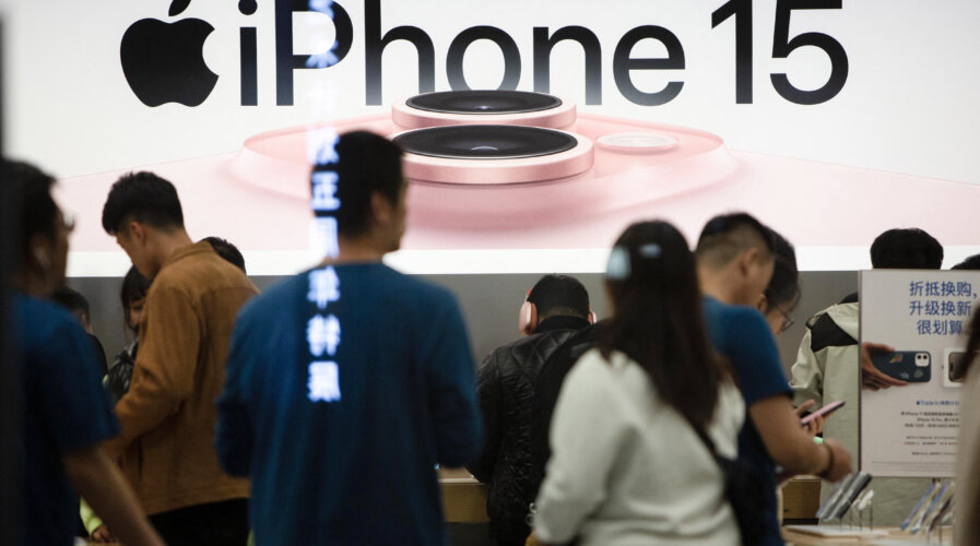 This photo taken on October 30, 2023 shows a poster for the new iPhone 15 at an Apple store in Shenyang, in China's northeastern Liaoning province. (Photo by AFP) / China OUT