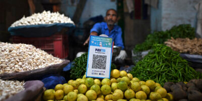 A vegetable vendor with a QR code of the Indian cellphone-based digital payment platform Paytm.